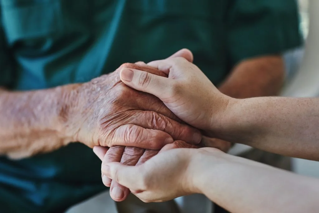 Support, senior man and woman holding hands with care, love and empathy while together for closeup